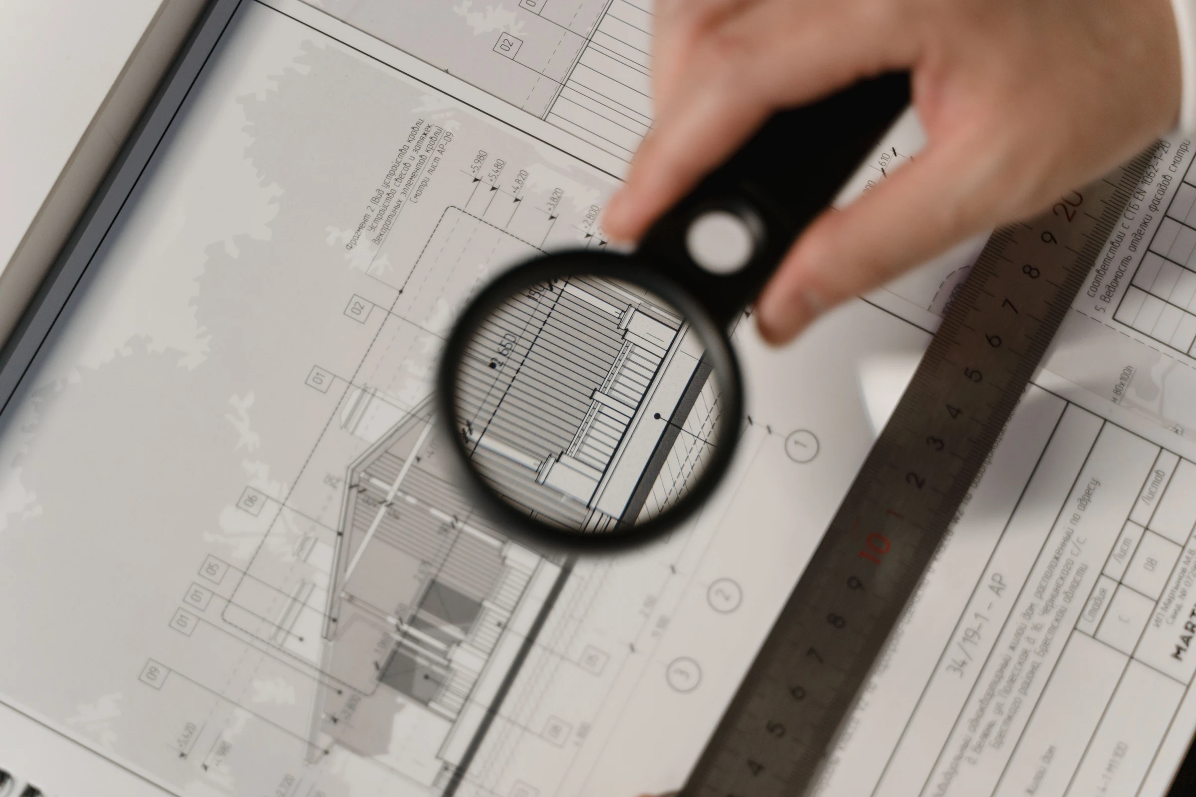 Architectural property plans examined through a magnifying glass