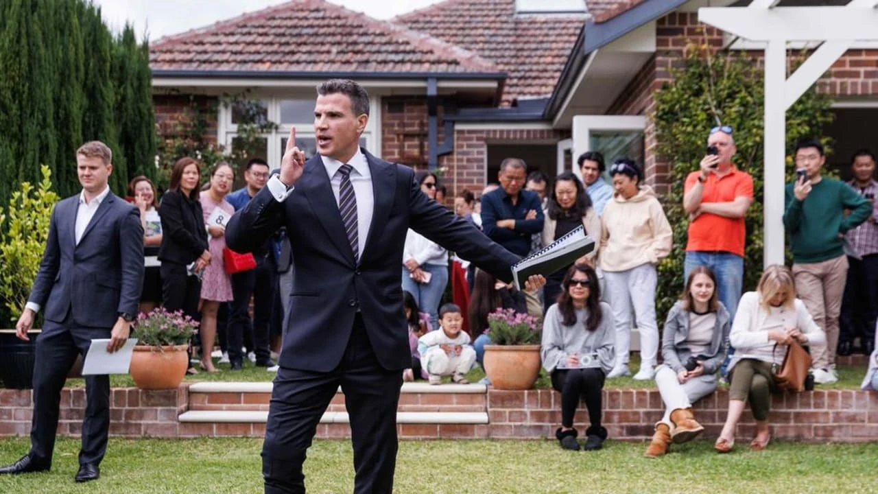Auctioneer addressing a crowd outside an Australian residential property