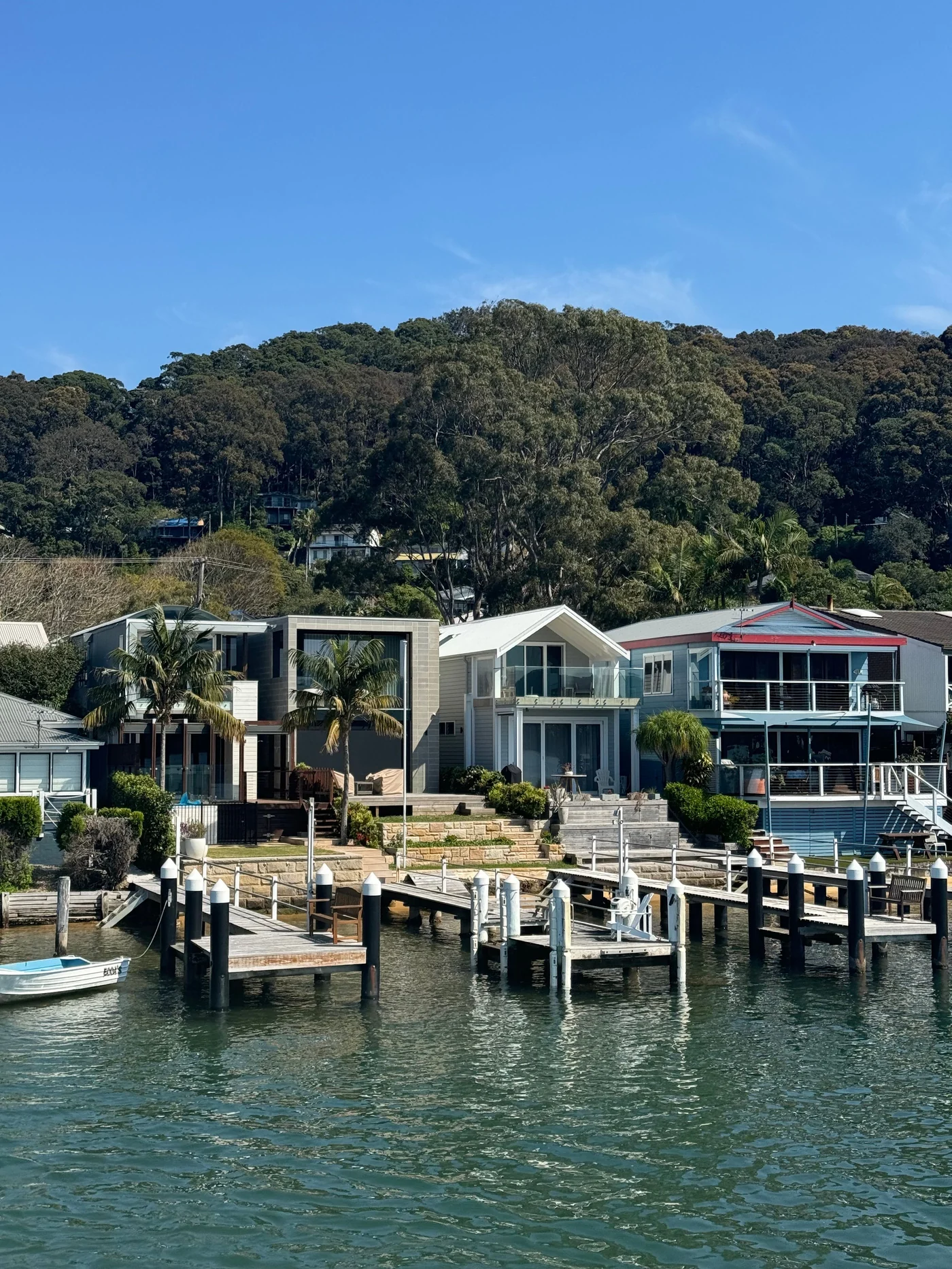 Australian waterfront homes and pontoons surrounded by bushland