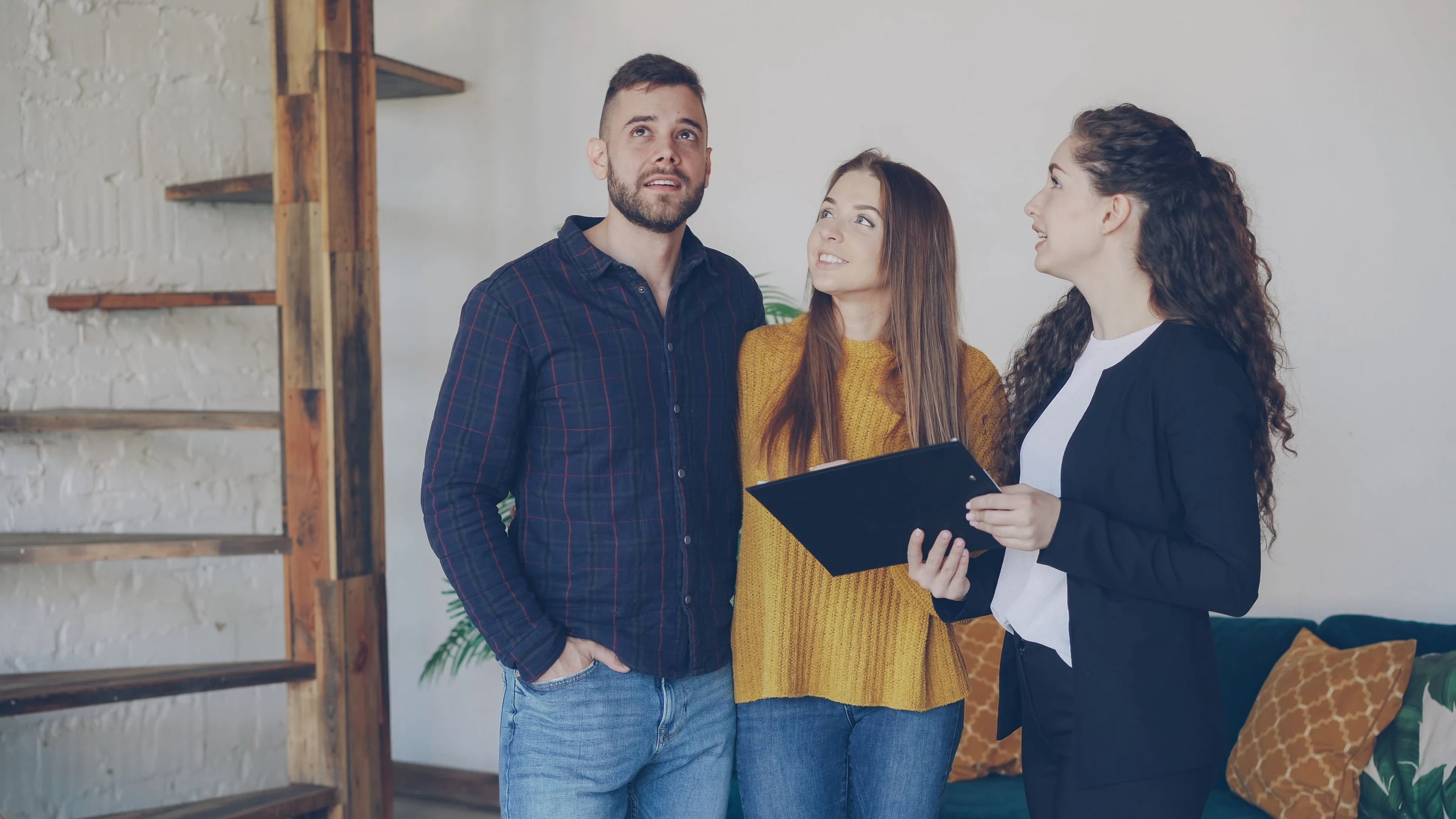 Buyer’s advocate guiding a couple during an inspection inside a property